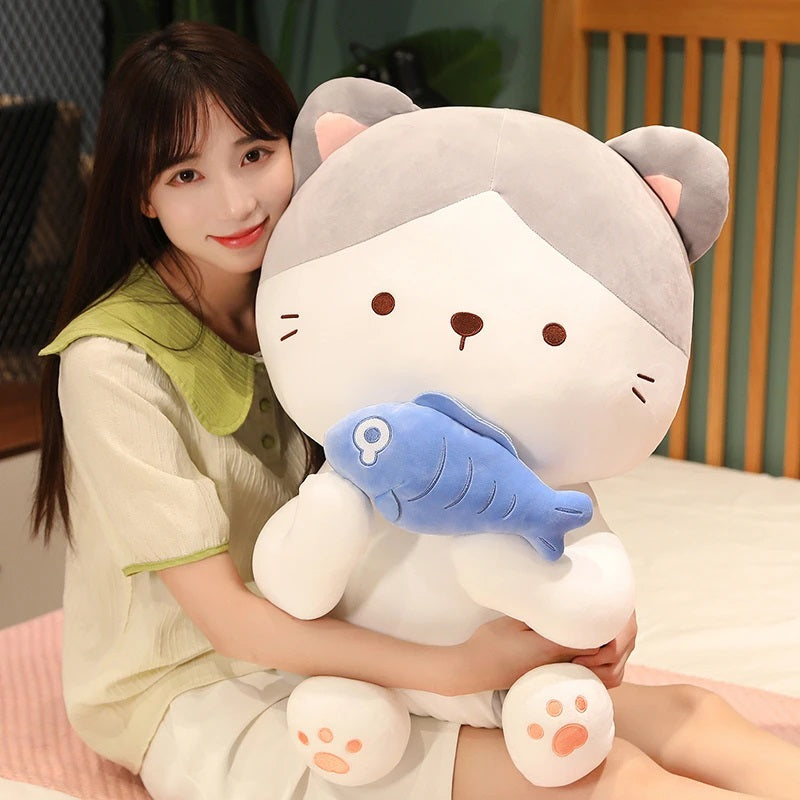 woman embracing a kawaii cat holding a fish plush