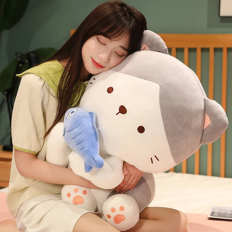 woman hugging a kawaii cat holding a fish plush