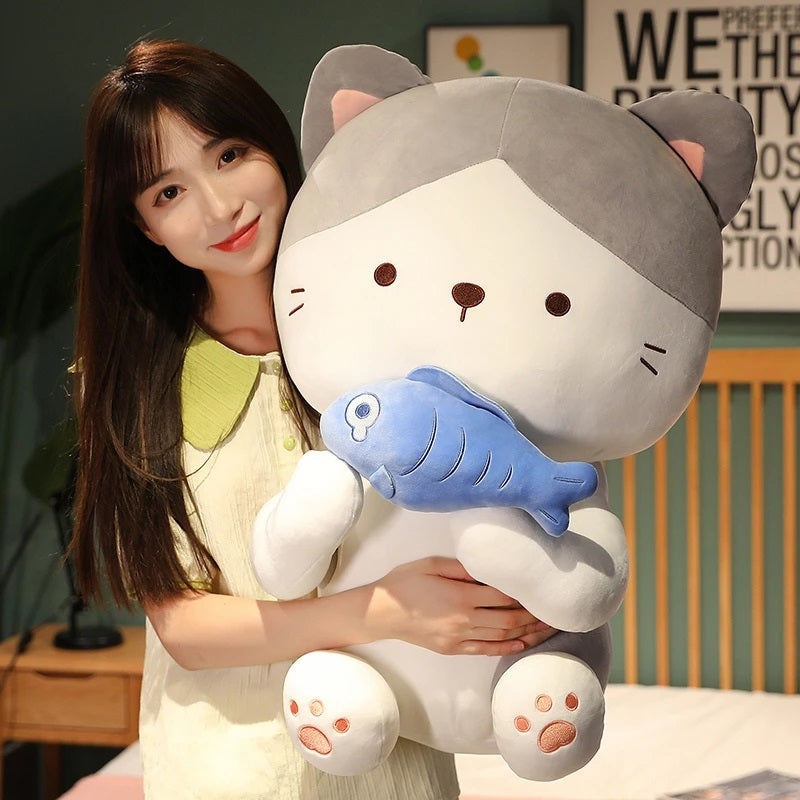 woman carrying a kawaii cat holding a fish plush