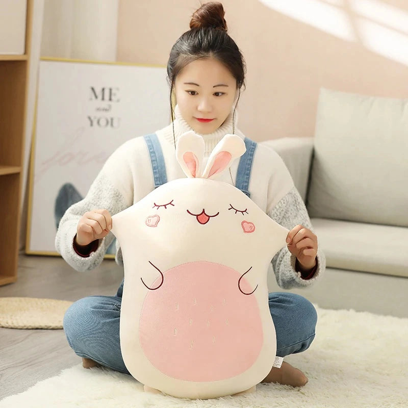 woman pinching a kawaii rabbit squishmallows plush