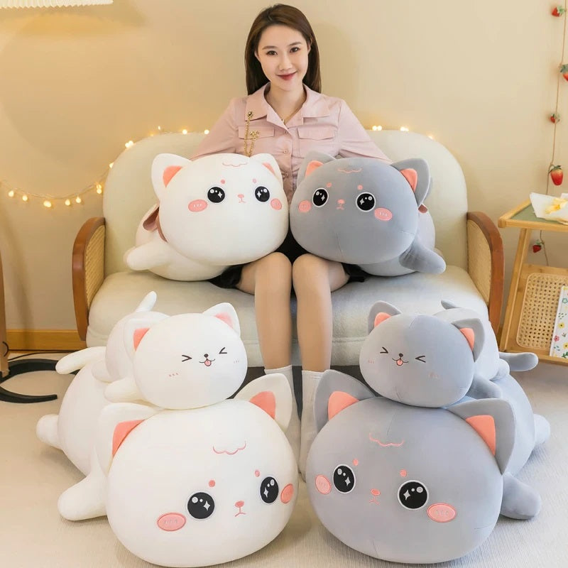 Women beside different sizes of Super Squishy Kawaii Cat Plush