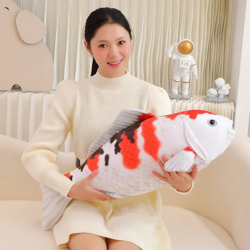 woman holding a koi fish plush