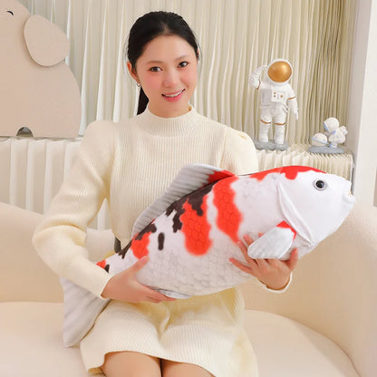 woman holding a koi fish plush