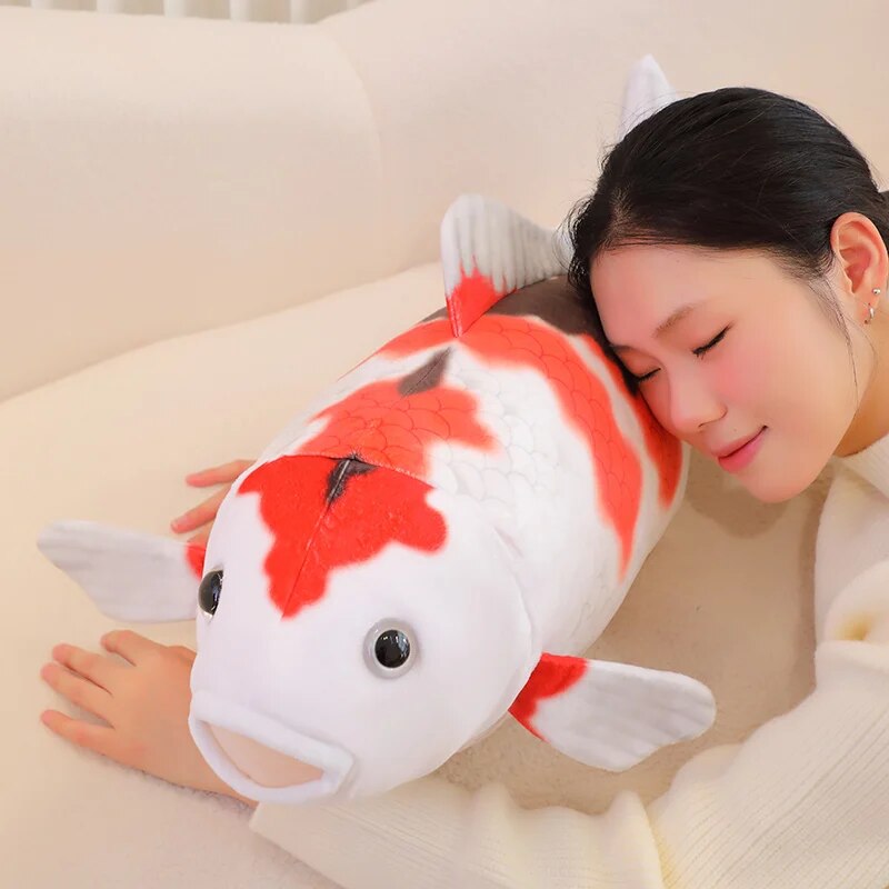 woman sleeping on a koi fish plush