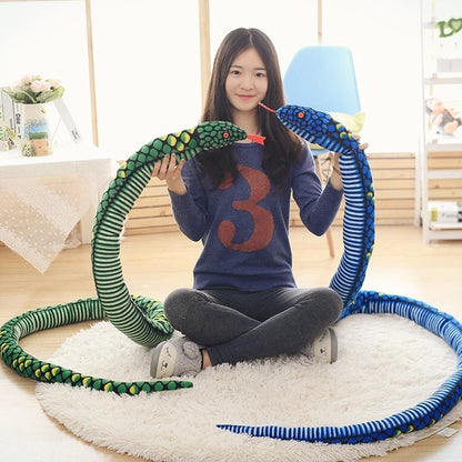 woman holding a green and blue giant snake stuffed animal toy