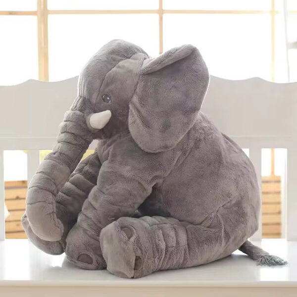 A grey baby elephant stuffed animal sitting.