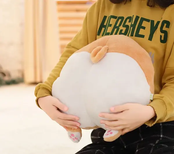 woman-holding-a-corgi-butt-plush-pillow