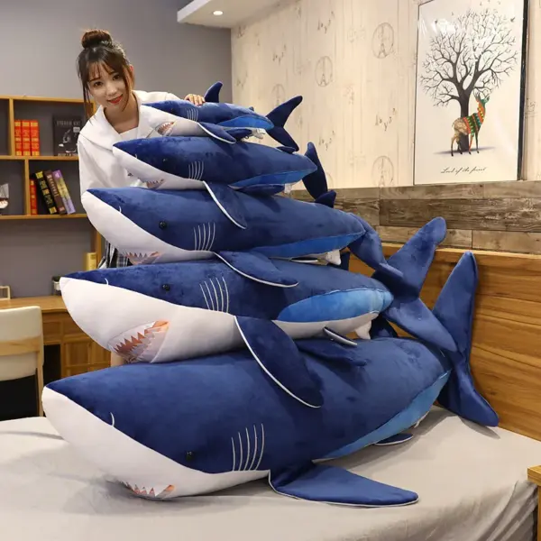woman-playing-with-different-sizes-of-shark-plush-toy