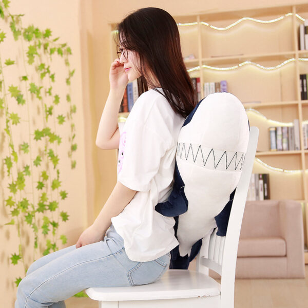 Woman sitting behind a Giant Shark Plush