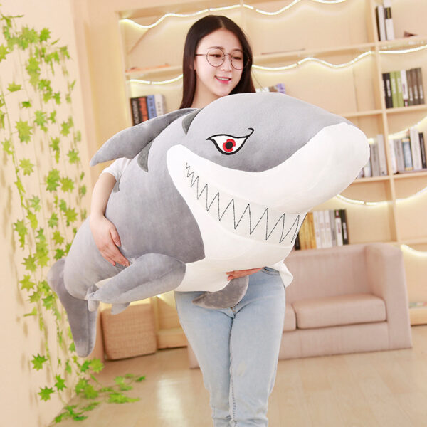 Woman carrying a Giant Shark Plush