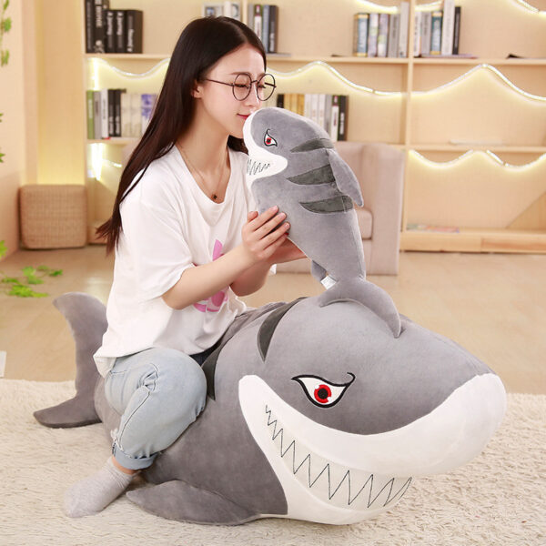 Woman sitting on a Giant Shark Plush