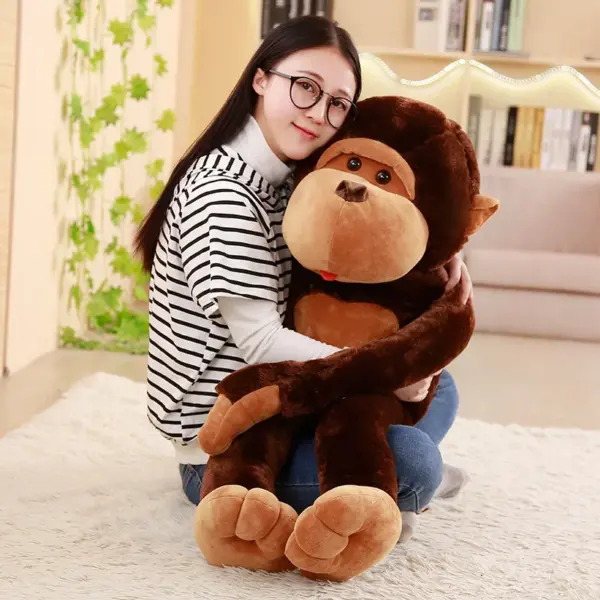 A young woman hugging a large brown monkey plush toy in a warmly lit living room.