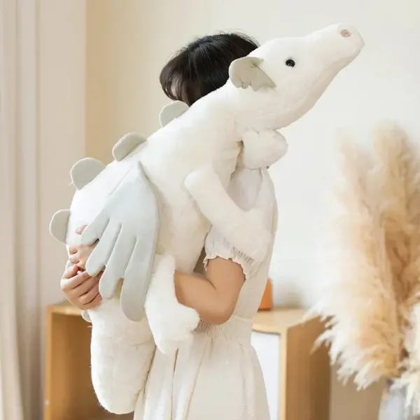 A young woman in a white dress hugging a large, fluffy white dragon plush toy in a warmly lit room.