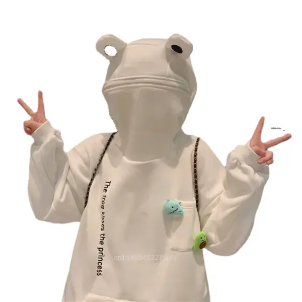 Woman wearing white frog hoodie with 3D eyes and zipped face